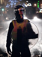 A British Transport Police public order officer on 'mutual aid', supporting the Metropolitan Police. British Transport Police riot gear.jpg