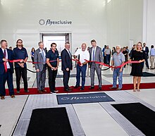 Tommy Sowers stands among other flyExclusive leadership and Kinston, NC Chamber of Commerce at the ribbon cutting of their two new aviation MRO hangars.