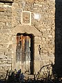 Puerta de la parroquia con crismón, arco conopial y escudo de San Juan de la Peña