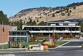 A color photograph of an academic building with a sign reading "Oregon Institute of Technology" in the foreground