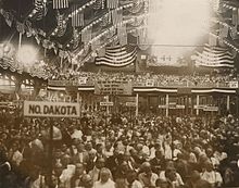 Delegates gathered on the convention floor Party banner decorating the balcony 276036v (cropped).jpg