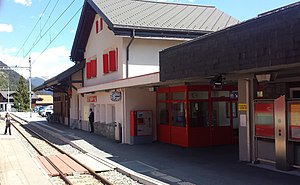 Two-story building with gabled roof and wings