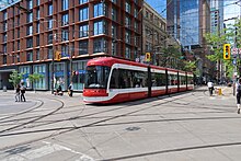 The TTC operates bus, streetcar, and subway systems. Streetcars on King St East 2022.jpg