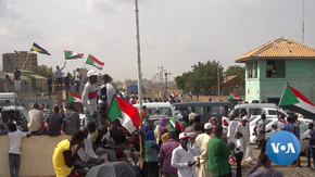 Sudanese protestors celebrate the 17 August 2019 signing of the Draft Constitutional Declaration between military and civilian representatives. Sudanese protestors celebrate signing of political agreement.png