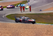 The winning car, leading three others