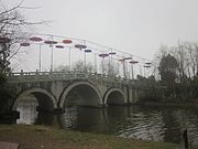 A three-arched bridge over Lake Yang in Yanghu Wetland Park