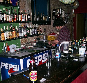 A bartender at work in a pub in Jerusalem, Israel.