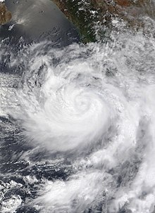 Hurricane Enrique on June 27 off the western coast of Mexico. The storm has a noticeable, but not clear eye, and more of the clouds are located to the southwest of the center.