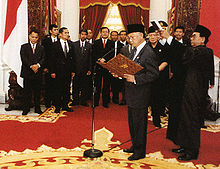 B. J. Habibie takes the presidential oath of office following Suharto's resignation, one week after the violence. He later appointed a fact-finding team to investigate the May riots. Habibie presidential oath.jpg