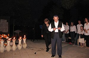 Holocaust survivor lights a torch in memory of...