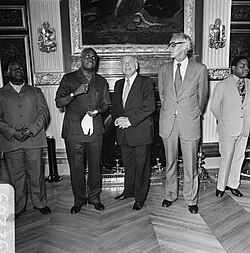 President of Zambia Kenneth Kaunda, Prime Minister Joop den Uyl and Minister Max van der Stoel at the Ministry of General Affairs on 13 June 1977 President Kaunda van Zambia in ons land vlnr Kaunda Den Uyl , Van der Stoel, Bestanddeelnr 929-2269.jpg