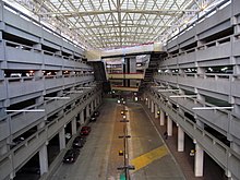 Quincy Adams (pictured) and Braintree stations include massive parking garages to accommodate suburban commuters. Quincy Adams garage facing northeast, January 2016.JPG