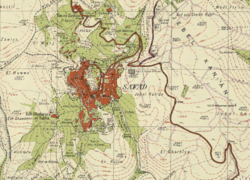 Safed street map (date 2018, white text and light grey streets) overlaid on a Survey of Palestine map (date 1942, black text, red urban areas and black streets), showing the relative locations of Safed to its three Mandate-era satellite villages: Al-Zahiriyya al-Tahta, Ein al-Zeitun and Biriyya.