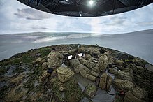 Royal Artillery soldiers training in a virtually simulated area, 2015 Soldiers from the Royal Artillery inside the FST Simulation tent, which uses 360 degree technology to assist in training during Exercise Steel Sabre. MOD 45158564.jpg