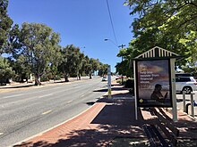 six lane road with trees in median