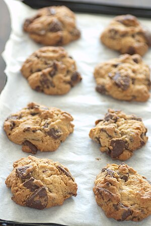 Chocolate chip cookies on parchment paper.