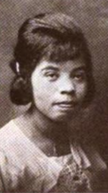 A young Black woman with her hair in a bouffant style