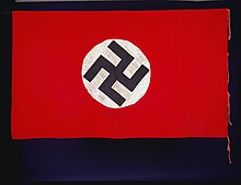 A flag from Nazi Germany found near the south bank of the Rapido River about 4,000 feet (1,200 meters) west of Monte Cassino by J. McQuorkindale on the night of 17-18 February 1944. The swastika appears to be left-facing in this image. Flag (AM 695001-1).jpg