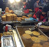 Vendors frying bindaetteok