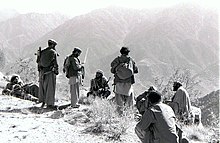 Black and white photograph of five Mujahideen resting on a hill-top during the Soviet war in Afghanistan