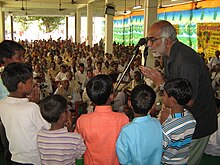 Rationalist, sceptic, and godman debunker Narendra Nayak during a miracle-exposure program in 2007. Narendra nayak-miracle exposure.jpg