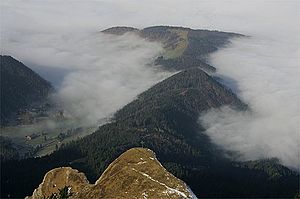 Blick vom Pilatus Richtung Nordwesten über das Klimsenhorn (mit Gipfelkreuz) ins vorwinterliche Eigental bei Hochnebel mit einer Obergrenze um 1000 m. Der nordöstliche Ausläufer des Klimsenhorns, die Lauelenegg, setzt sich im bewaldeten Rücken des Höchberg (1198 m) fort, danach der Einschnitt Chräigütsch (1081 m) und dahinter die umwaldete Matte der Würzenegg (1173 m). Am linken Bildrand ist unter dem Ganterseiwald das Gehöft beim Buechstäg (1006 m) zu erkennen.