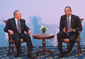 Obama and Castro sitting together on stage at a press event
