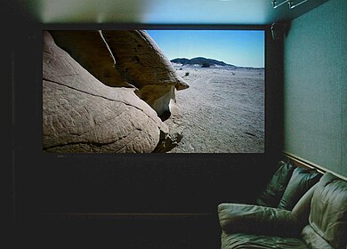 Projection screen in a home theater, displaying a high-definition television image.