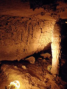 Formation inside one part of the cave, lit with two temporary cage lights (light bulbs inside metal safety cages)