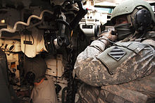 A view in a M1A1 Abrams tank of the gunner's station (bottom left) and commander's station (top right) 3rd ID M1A1 Abrams TC and Gunner 2008.jpg