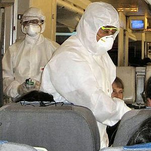 Chinese inspectors on an airplane, checking pa...