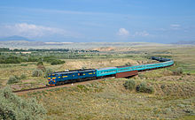 Train 22 Kyzylorda - Semipalatinsk, hauled by a Kazakhstan Temir Zholy 2TE10U diesel locomotive. Picture taken near Aynabulak, Kazakhstan. KTZ 2TE10U Aynabulak.jpg