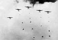 Battle of Menado: V-formation of Type 96 “Tina” transports dropping men of the Yokosuka 1st SNLF over Langoan airfield, Manado, Celebes, in January 1942