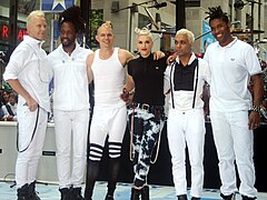 A color photograph of No Doubt bowing together after a concert in May 2009.