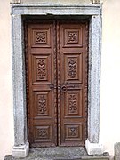 Right side wooden door of the Parish Church of Croveo, Italy, representing the Nativity of Mary