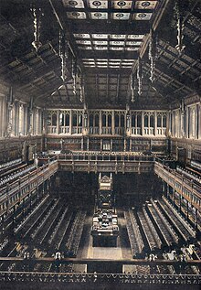 The old House of Commons chamber, showing dark veneer on the wood, which was purposely made much brighter in the new chamber. Old House of Commons.jpg