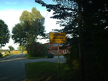 City limits sign; this city is called Emlichheim in High German and Emmelkamp in Low German. Ortsschild Emlichheim - Emmelkamp.jpg