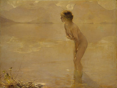 A nude woman standing along the beach