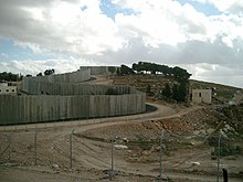 The barrier, called an "apartheid wall" by pro-Palestinian groups, "a security fence" by Israel Security Fence and settlement.jpg