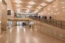 View of the Shuttle Passage facing the subway station entrance; the ramp at right leads to street level Shuttle Passage.jpg