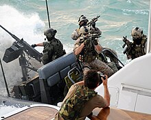 Special Boat Team 20 navigates a rigid-hull inflatable boat while a SEAL team boards a yacht US Navy 090427-N-4205W-352 A Special Warfare Combatant-Craft Crewman (SWCC) assigned to Special Boat Team (SBT) 20 navigates a rigid-hull inflatable boat.jpg