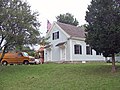 Belfry, front of schoolhouse, craftsmen vehicles