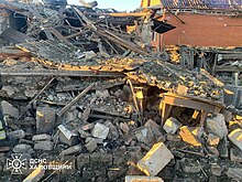 A man under the rubble of a destroyed house in Vovchansk Destructions in Vovchansk after Russian shelling (2024-05-12) 02.jpg