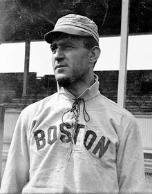 A man wearing a baseball cap and jersey with "Boston" written across the chest