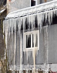 Icings resulting from meltwater at the bottom of the snow pack on the roof, flowing and refreezing at the eave as icicles and from leaking into the wall via an ice dam. Ice dam and roof leakage.jpg