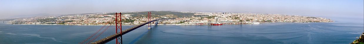 Panoramic view of Lisbon from the top of Cristo-Rei, with 25 April Bridge in the foreground.