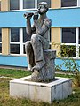 Kluk s píšťalkou, mramorová socha před budovou školy v Plzni