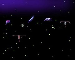 Six relatively large variously-shaped organisms with dozens of small light-colored dots all against a dark background. Some of the organisms have antennae that are longer than their bodies.