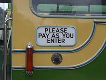 A polite notice on the side of a bus that reads "please pay as you enter" Southdown bus 199 (KUF 199F), 2009 Amberley Bus Day.jpg