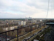 The abandoned city of Pripyat, Ukraine, following the Chernobyl disaster. The Chernobyl nuclear power plant is in the background. View of Chernobyl taken from Pripyat.JPG